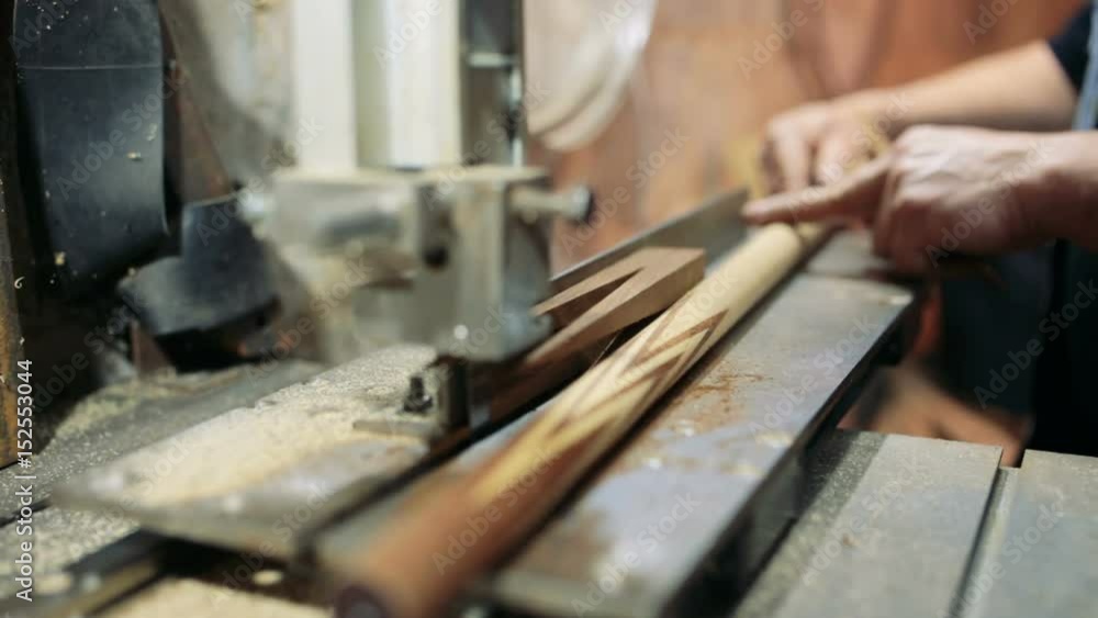 Luthier forms a billiard cue running on a band saw. Luthier forms a billiard cue running on a band saw.