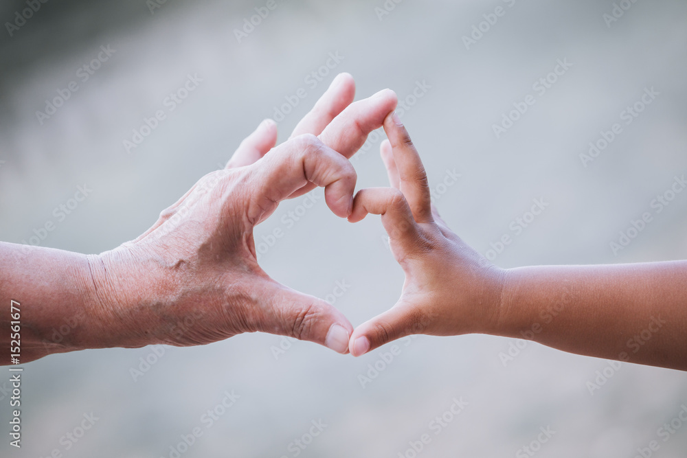 Grandmother and kid little girl making heart shape with hands together with love in vintage color tone Grandmother and kid little girl making heart shape with hands together with love in vintage color tone