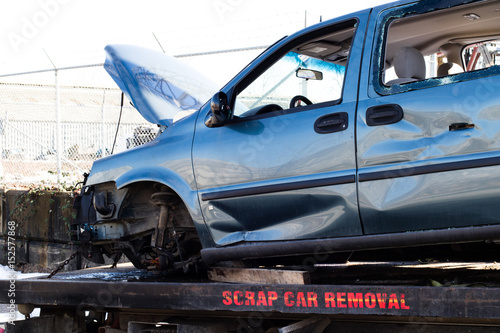 Recycling scrap car removal service for future dismantling and metal and parts reuse.