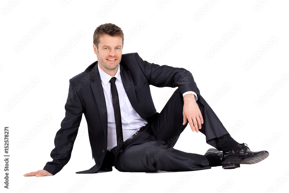 Smiling businessman sitting on the floor Smiling businessman sitting on the floor