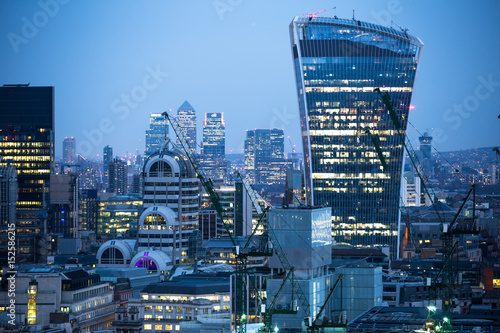 City of London business aria view at night. Walkie-Talkie building and Canary Wharf at the background 