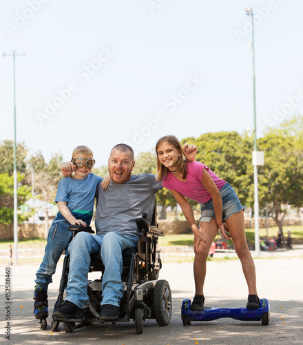 Disabled father playing with children.