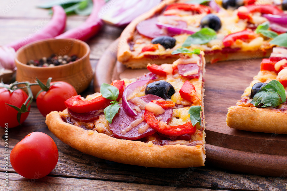 Delicious pizza served on wooden table. Italian pizza close up, top view, horizontal