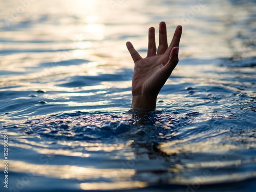 Drowning victims, Hand of drowning man needing help. Failure and rescue concept. photo