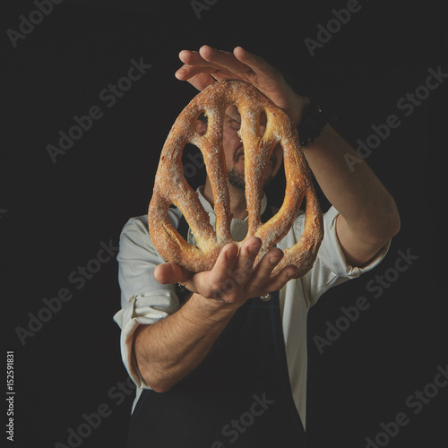 Baker holding fougas bread photo