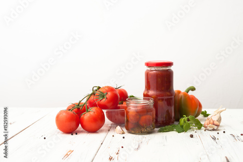 Recipes for tomatoes in jars on white