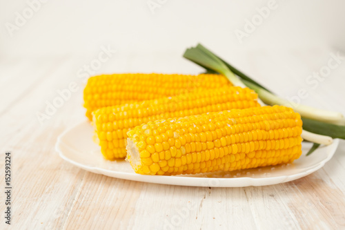 Two of the cob cooked corn on white background