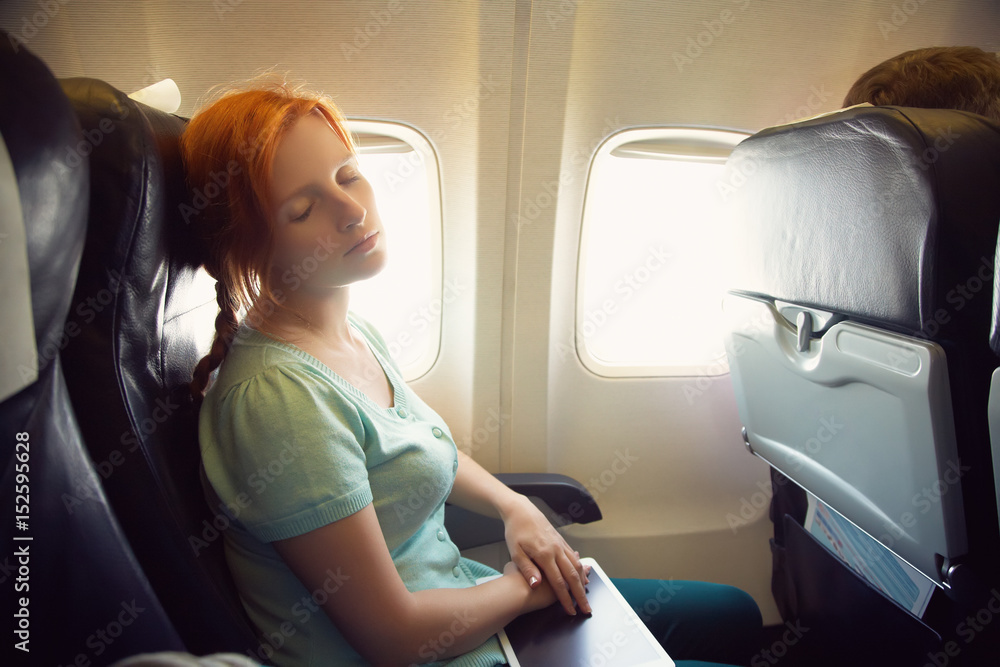 Naklejka premium woman in an airplane