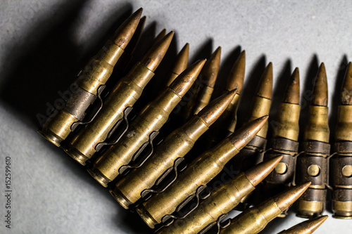 Bullets in a iron belt lined as a weapon, crime, criminal, war, protection, scary, sinister, danger, violence, killer concept background