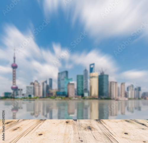 shanghai skyline in afternoon and reflection with wooden floor