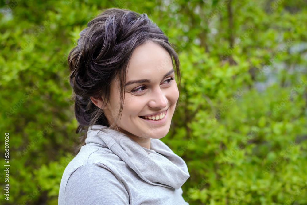 Portrait of a beautiful girl on a background of green foliage Portrait of a beautiful girl on a background of green foliage