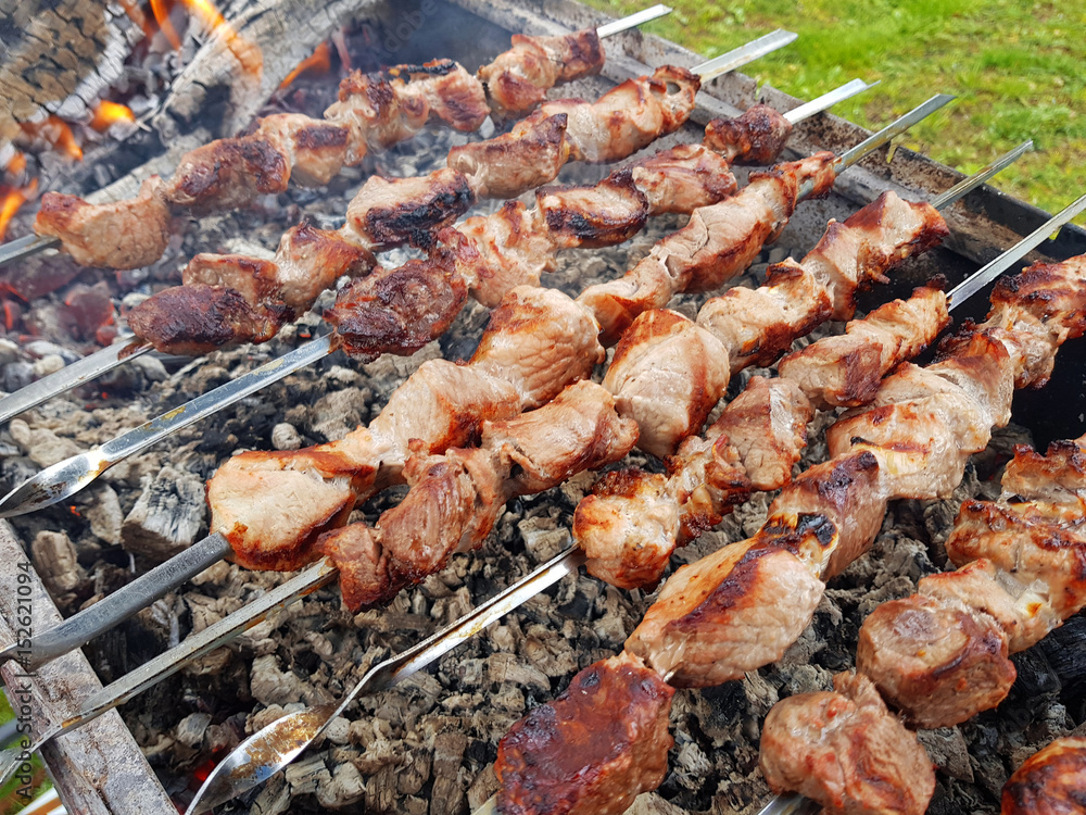 Slices of meat prepare on fire (shish kebab).