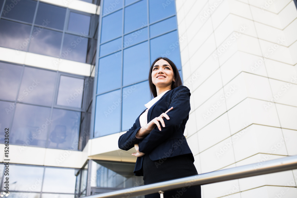 Young business girl in front of modern business offices center Young business girl in front of modern business offices center