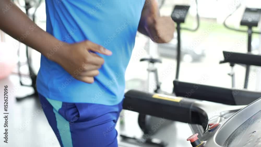 Athletic man running on treadmill at the gym, active lifestyle and sport Athletic man running on treadmill at the gym, active lifestyle and sport