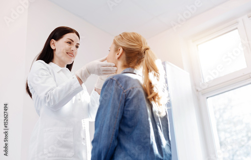 Beautiful positive doctor doing medical examination