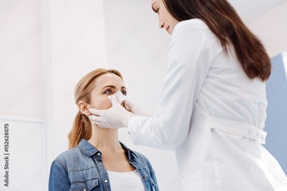 Pleasant female patient reshaping the form of her nose Pleasant female patient reshaping the form of her nose