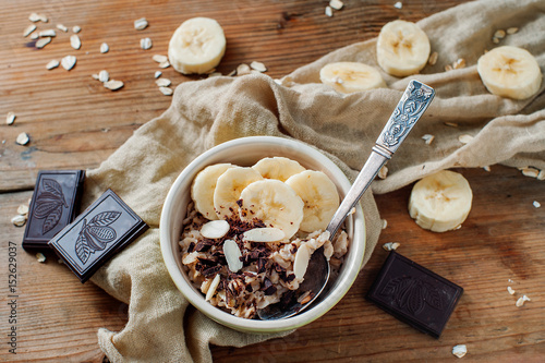 Pieces of dark chocolate and banana accompany light cereal breakfast