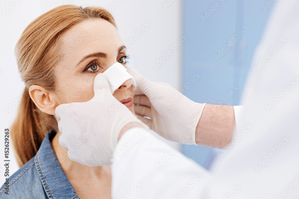Nice serious woman undergoing cosmetic surgery Nice serious woman undergoing cosmetic surgery