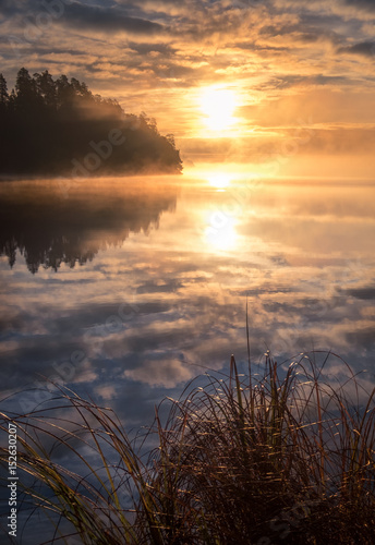 Scenic landscape with lake and beautiful sunrise at morning