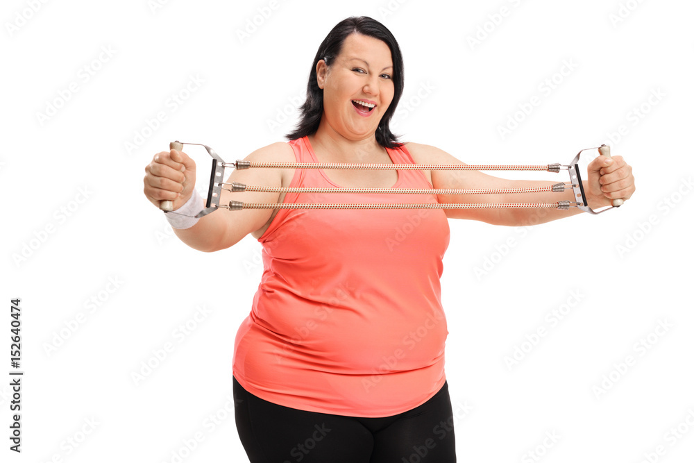 Joyful overweight woman exercising with a resistance band Joyful overweight woman exercising with a resistance band