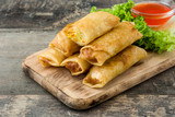 Vegetable spring rolls on wooden table background
