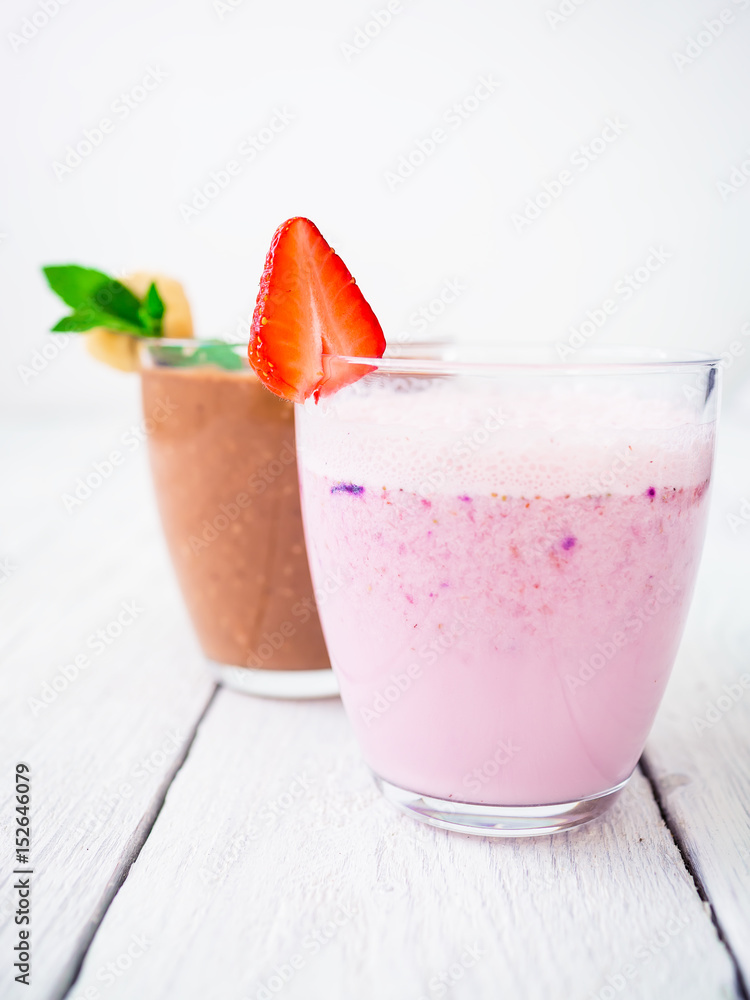 Blueberry smoothie with strawberry and chocolate, banana smoothie on white wood background. Fresh milkshake Blueberry smoothie with strawberry and chocolate, banana smoothie on white wood background. Fresh milkshake