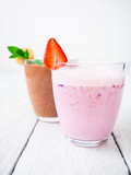 Blueberry smoothie with strawberry and chocolate, banana smoothie on white wood background. Fresh milkshake