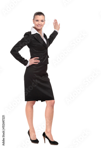 Smiling business woman points to advertise on the wall