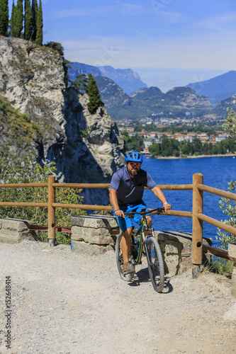 Fototapeta Naklejka Na Ścianę i Meble -  Mountain biking on Lake Garda, Sentiero della Ponale, Riva del Garda, Italy