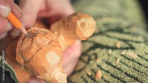 a craftsman carves wood photo