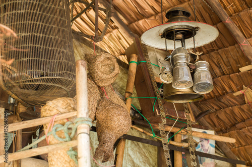 wooden wall  in old Fishing tool and old farm tools and broom