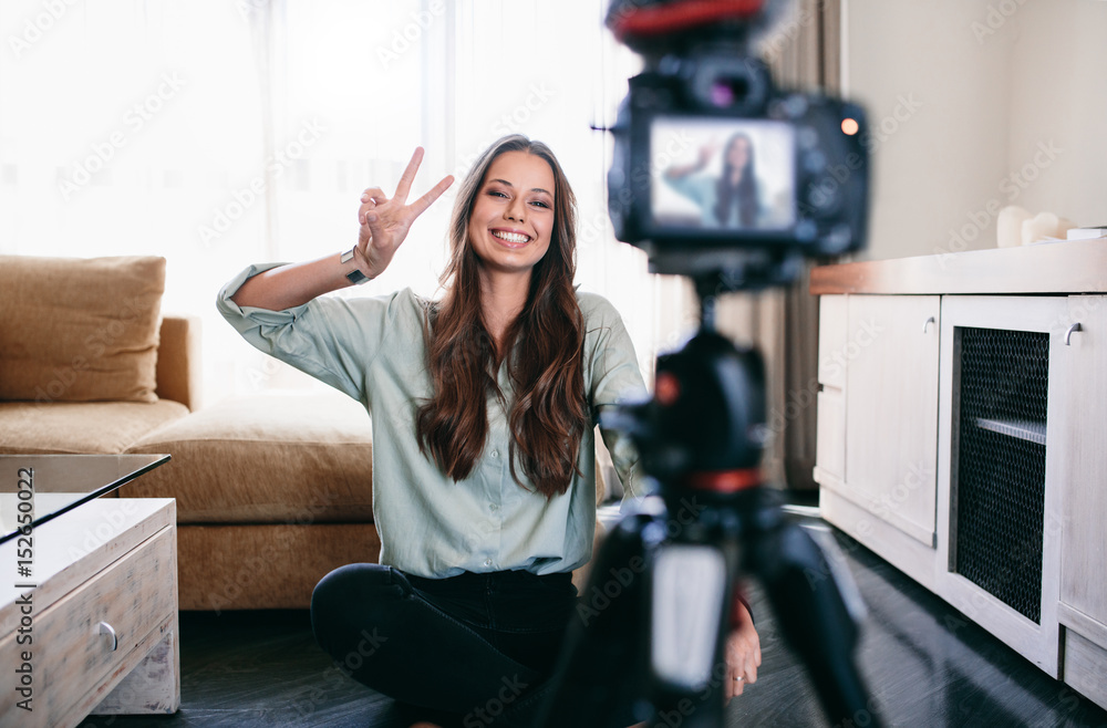 Young woman recording content for her blog. Young woman recording content for her blog.