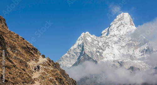 Tourists on the trail near Dingboche village. Ama Dablam (6814 m) in the background - Everest region, Nepal, Himalayas photo