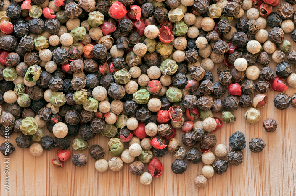 Mixed peppercorn on a wooden table Mixed peppercorn on a wooden table