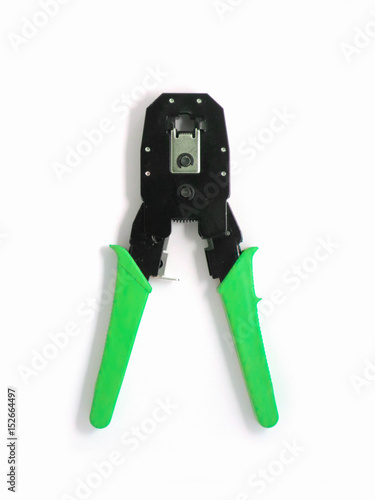 Registered Jack crimper tool, isolated on a white background. Network jumper knife colored black and green. Close up, top view.