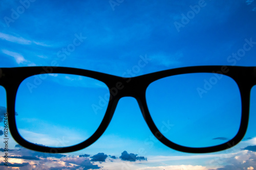 Hand Hold Glasses to the Sky,Glasses and cloudy sky.Heavenly Skies pastel background nature. Open new perspectives