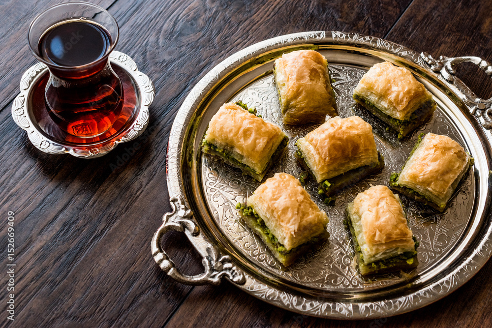 Turkish Dessert Baklava with tea on silver tray.