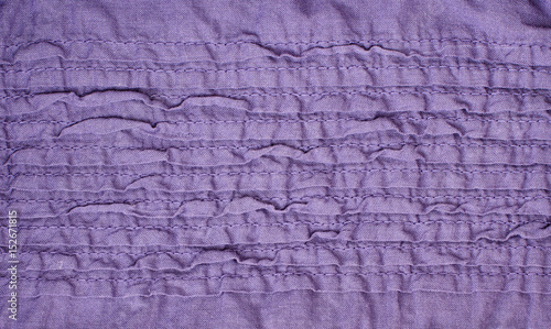Purple fabric with irregular stitched folds