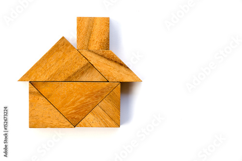 Wooden tangram puzzle in home shape on white background