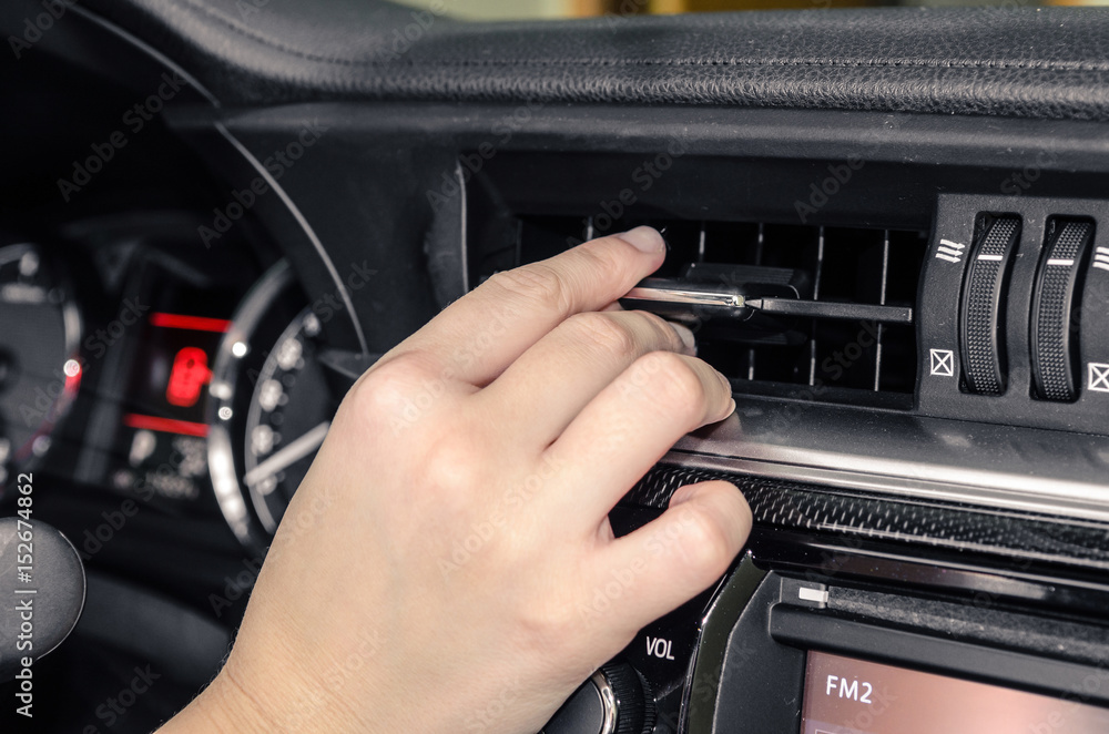 Adjusting the air vent of a car Adjusting the air vent of a car
