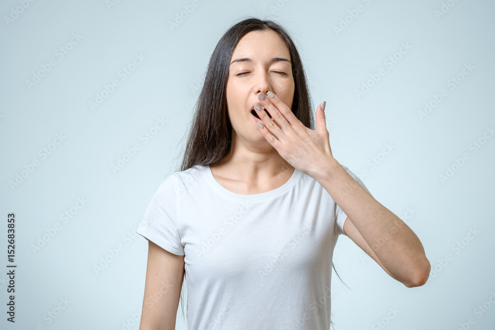 Beautiful woman yawns of boredom isolated Beautiful woman yawns of boredom isolated