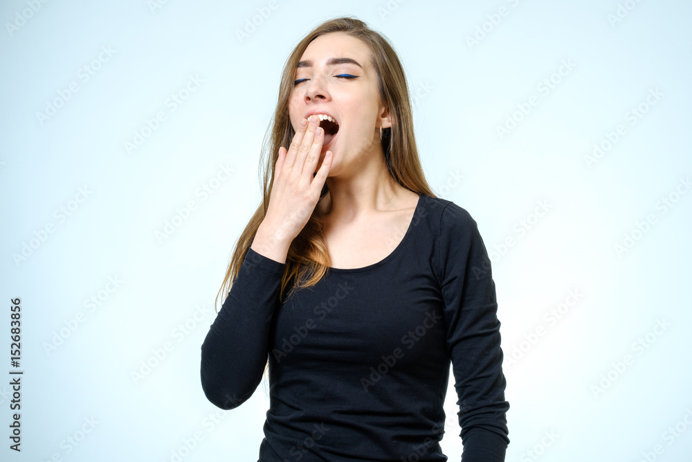 Beautiful woman yawns of boredom isolated Beautiful woman yawns of boredom isolated