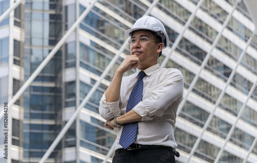 Portrait of asian businessman stand at sidewalk in the city and dreaming of success. Portrait of asian businessman stand at sidewalk in the city and dreaming of success.