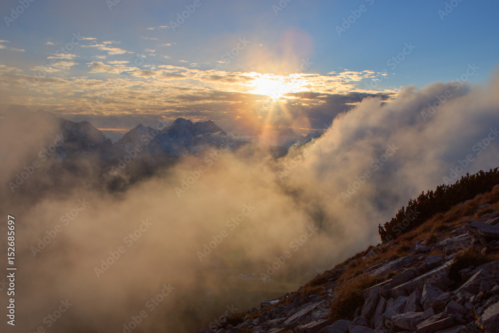 Fototapeta premium Sunset above clouds in the mountains