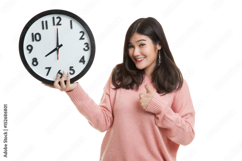 Young Asian woman thumbs up with a clock. Young Asian woman thumbs up with a clock.