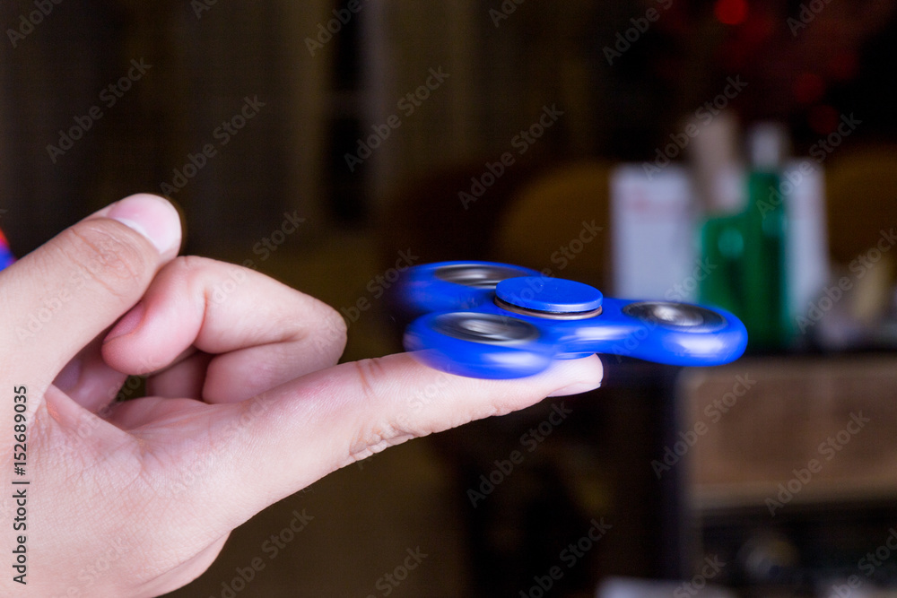 Close-up of teenager spinning a fidget spinner on finger Stock-Foto | Adobe  Stock