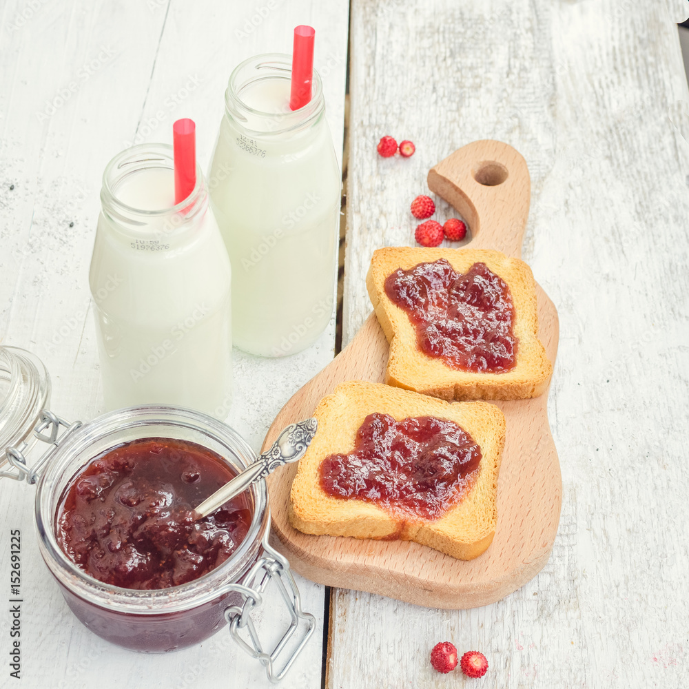 Toasts with strawberry jam and milk Toasts with strawberry jam and milk