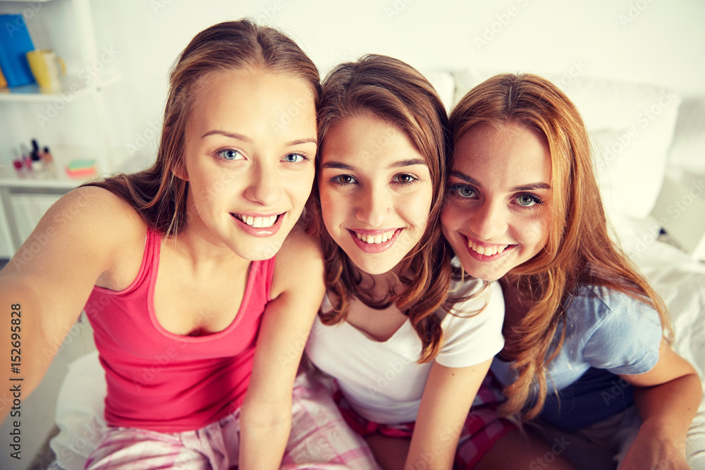 happy friends or teen girls taking selfie at home happy friends or teen girls taking selfie at home