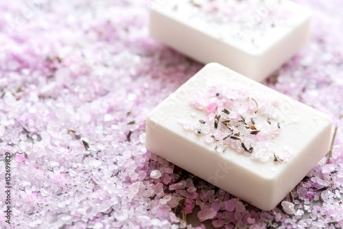 Spa composition with pink sea salt and two natural soaps Copy space 