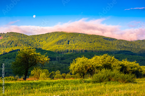 moonrise over the mountain in rural area at sunset